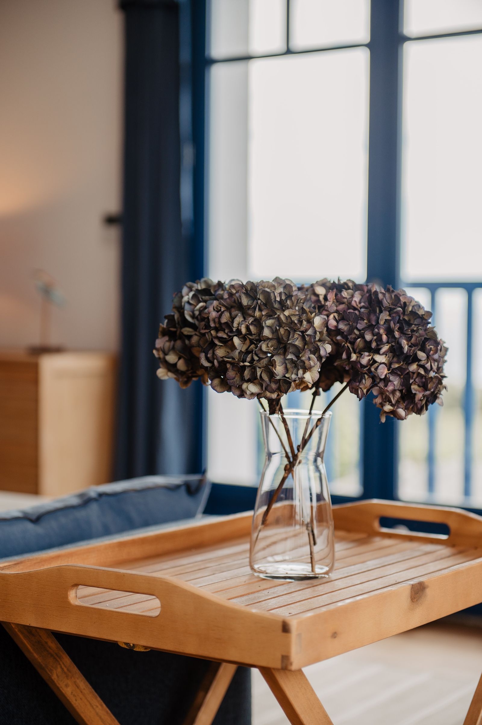Dried hydrangeas on a wooden tray